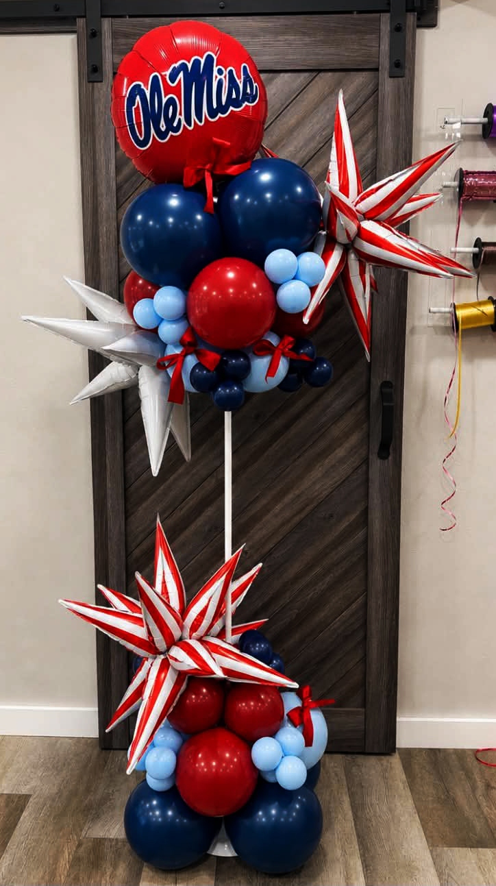 Pair of tall corporate balloon columns in chrome gold and black with SouthStar Bank '105 Years' branded toppers