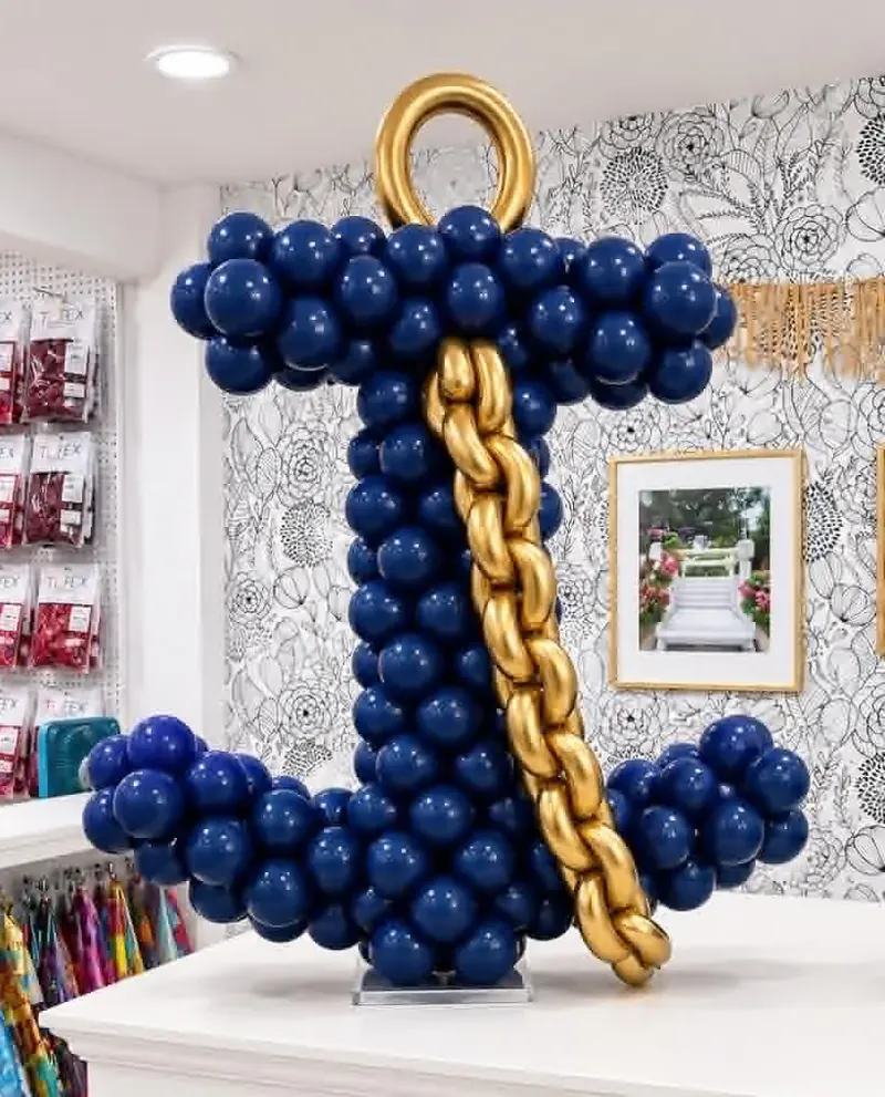 Custom navy balloon anchor sculpture with gold chrome chain and gold ring topper