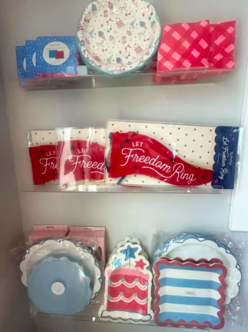 Patriotic 4th of July party supplies: Let Freedom Ring banners, star napkins, red and blue gingham napkins, and scalloped cake plates