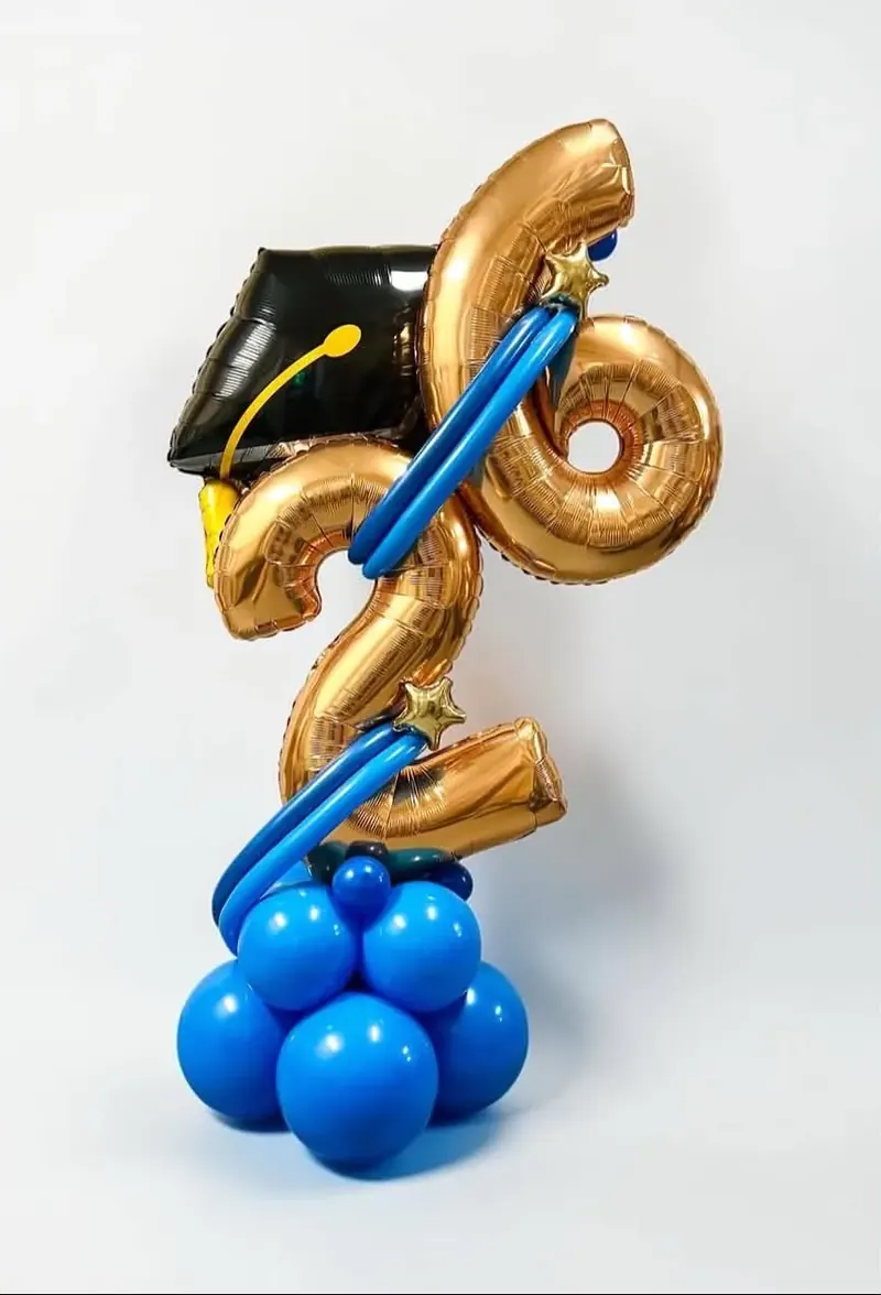 Graduation balloon stack with gold class of 2026 number balloons, black grad cap foil, and royal blue balloon base