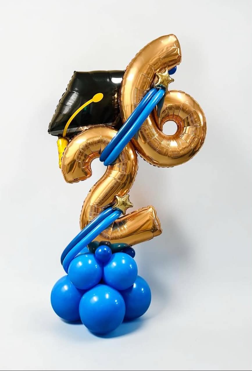Graduation balloon stack with gold class of 2026 number balloons, black grad cap foil, and royal blue balloon base