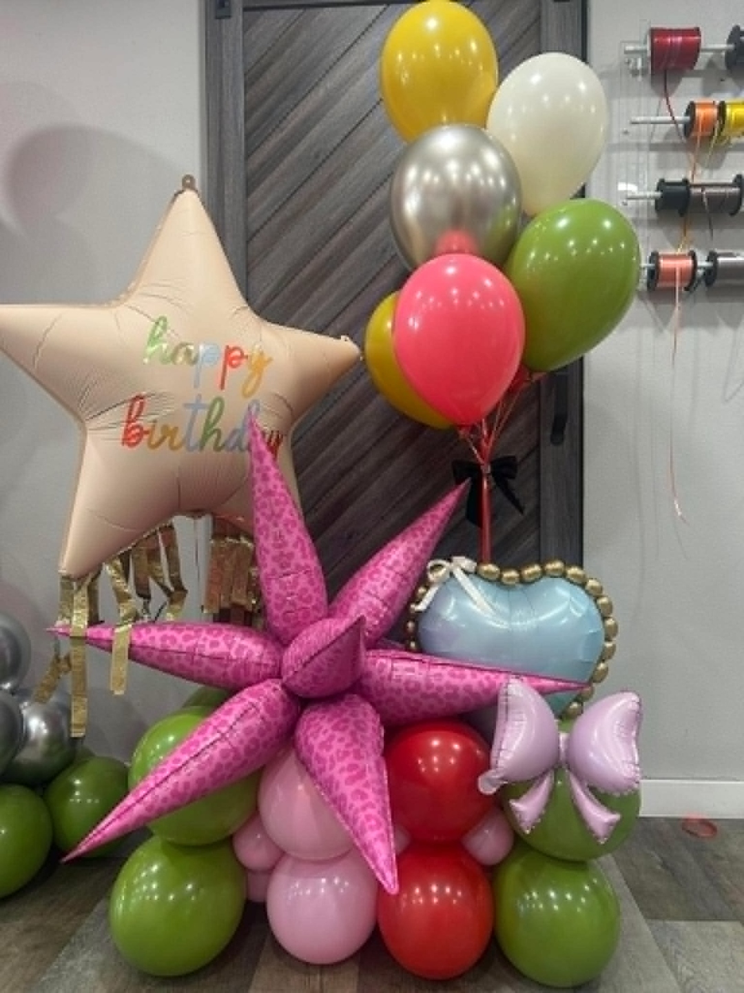 Hot pink leopard print star balloon stack with cream Happy Birthday star foil, pink heart, and lime green and red balloon base